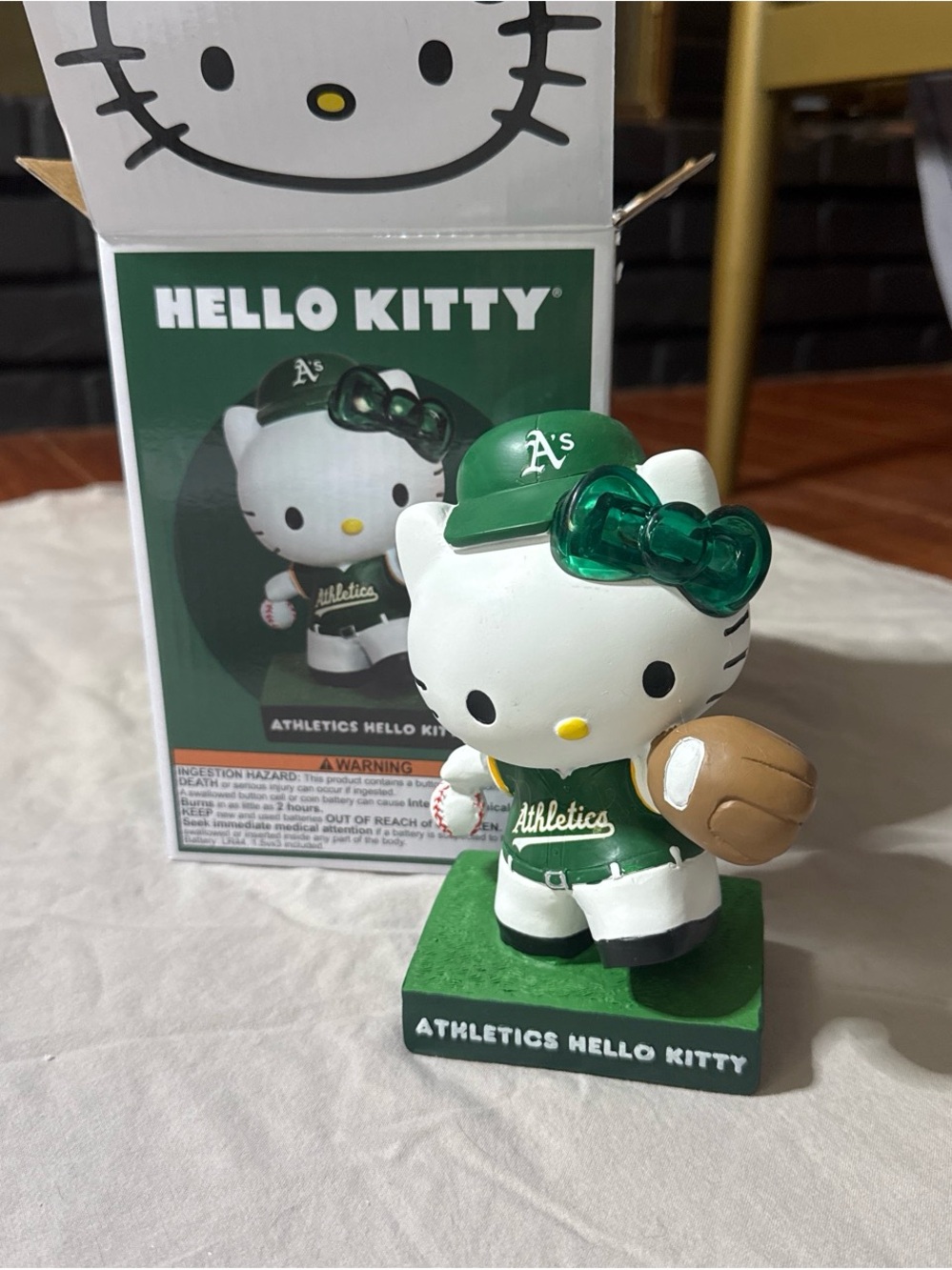 Hello Kitty Athletics Figurine in Green and Brown